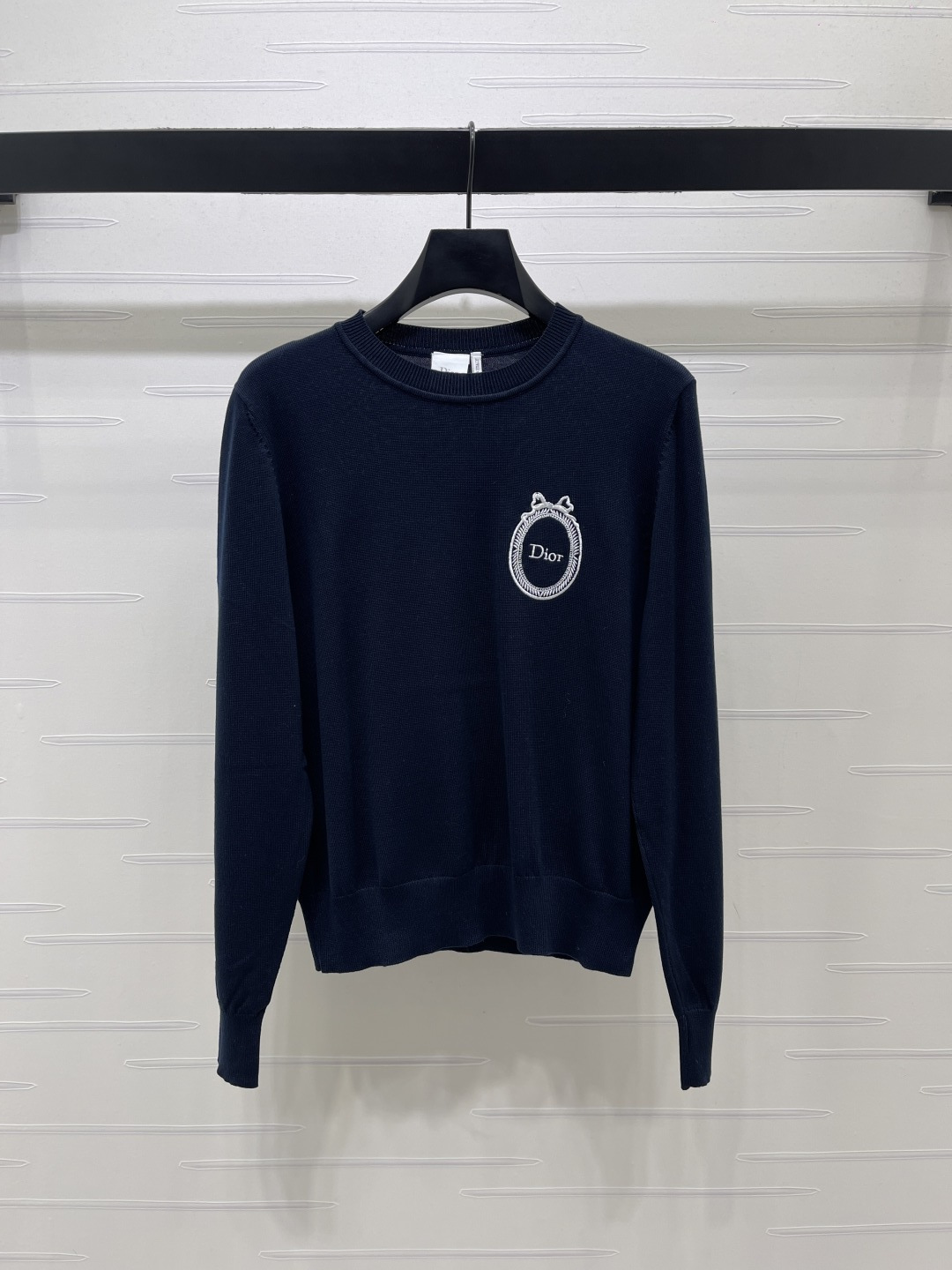 Embroidered crest knit sweater